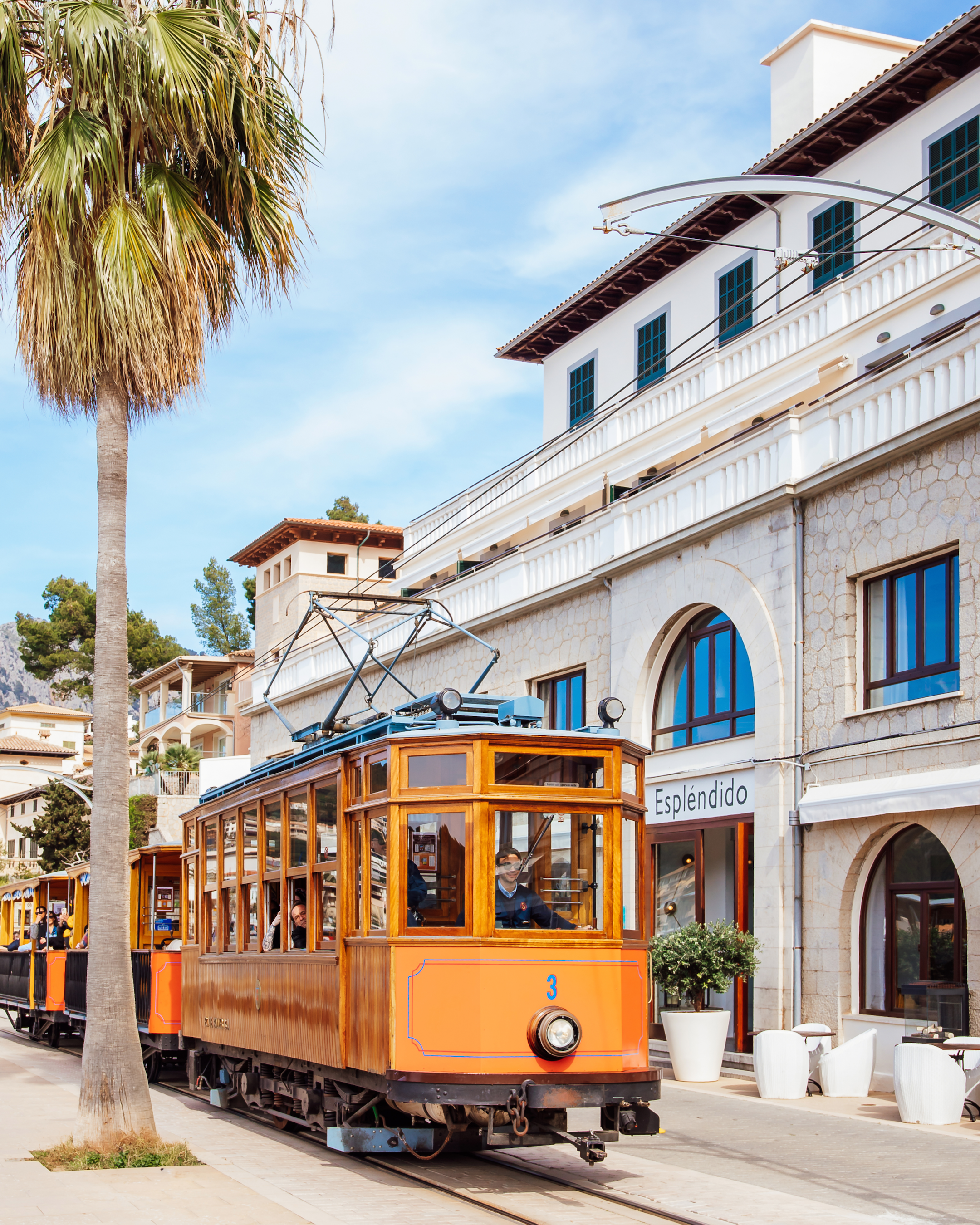Historic Sóller tram passing Hotel Espléndido on the seafront promenade in Port de Sóller, Mallorca.