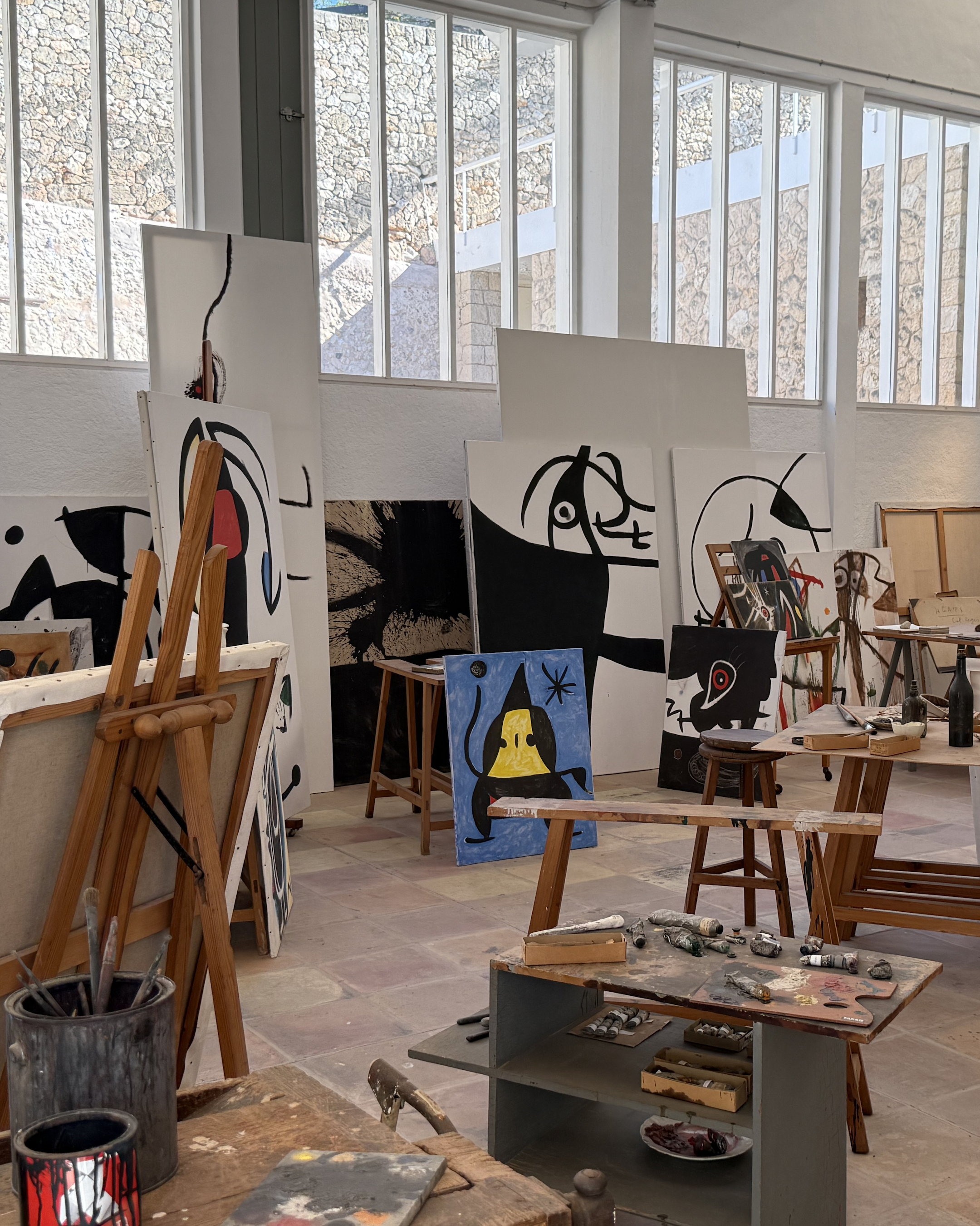 Interior of Joan Miró's preserved studio at Fundació Miró Mallorca, featuring canvases, painting tools and iconic abstract compositions.