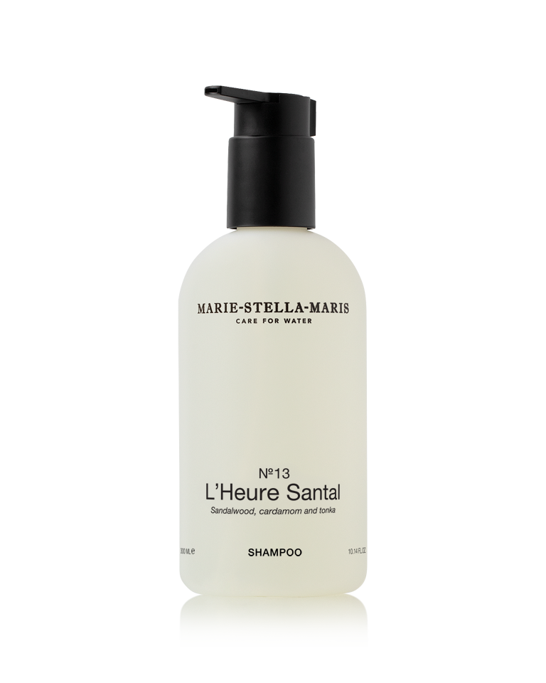 Marie-Stella-Maris No.13 L'Heure Santal Shampoo (300 ml) in a white pump bottle with a black dispenser. The minimalist packaging features the No.13 L'Heure Santal fragrance with notes of sandalwood, cardamom and tonka.