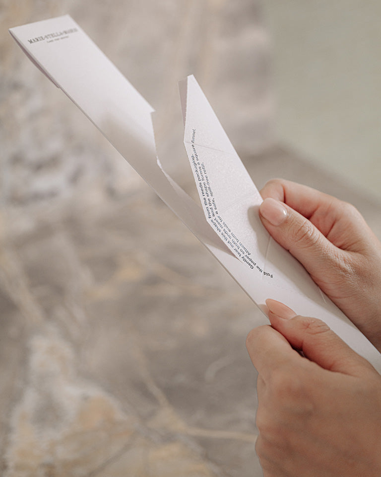 Marie-Stella-Maris Diffuser Reeds 100 ml packaging being opened by hand, featuring a minimalist white box with elegant branding against a soft neutral background.