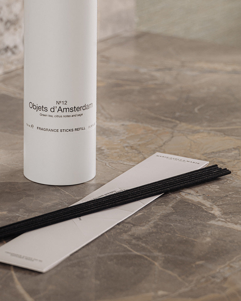 Marie-Stella-Maris No.12 Objets d’Amsterdam fragrance sticks refill with black diffuser reeds displayed on a marble surface.