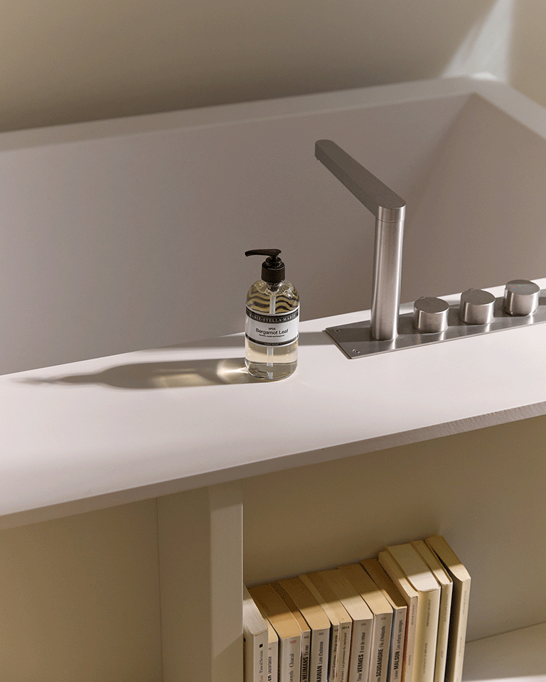 Marie-Stella-Maris No.05 Bergamot Leaf limited edition summer scent hand soap 250 ml placed beside a modern sink in a minimal bathroom setting, with warm light and clean, neutral tones.