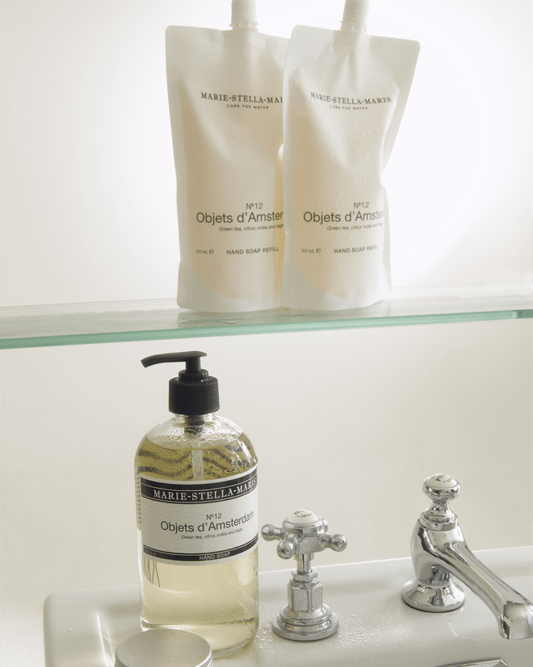 Marie-Stella-Maris No. 12 Objets d'Amsterdam hand soap refill pouches 500 ml and hand soap 250 ml on a bathroom sink with chrome taps.