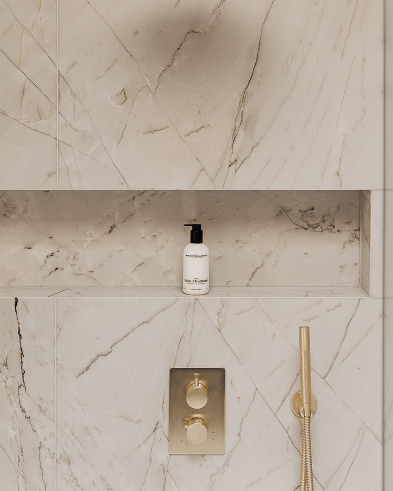 Bottle of Conditioner Objets d'Amsterdam 300 ml with wheat protein and pro-vitamin B5 on marble shower shelf