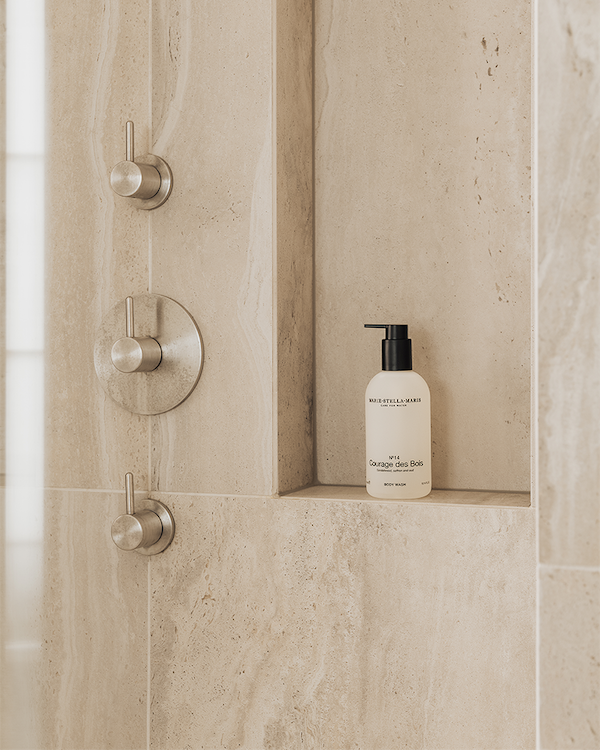 Bottle of Body Wash Courage des Bois 300 ml placed in a beige tiled shower niche with modern metal controls nearby