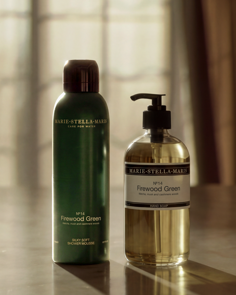 Marie-Stella-Maris No. 14 Firewood Green shower mousse and hand soap displayed in warm sunlight.