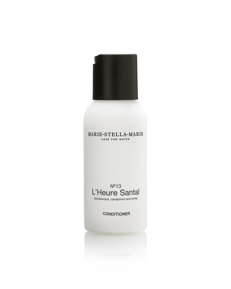 White bottle of Marie-Stella-Maris No. 13 L’Heure Santal conditioner with a black cap, featuring a warm, woody fragrance of sandalwood, cardamom and tonka.