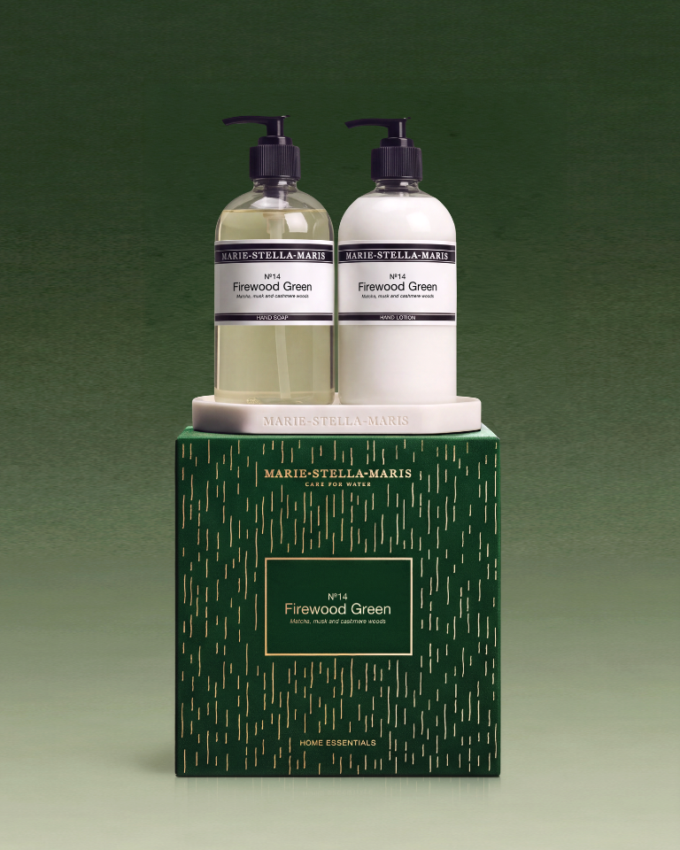 Festive Marie-Stella-Maris No. 14 Firewood Green hand soap and hand lotion duo displayed on a white tray atop an elegant dark green and gold gift box.