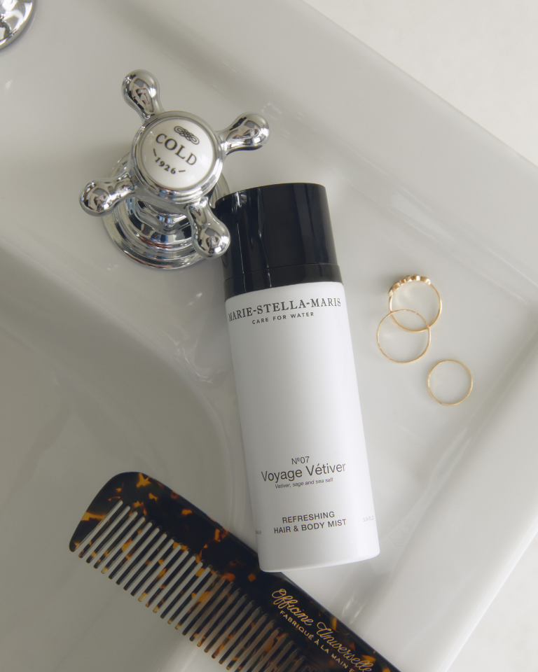Bottle of Marie-Stella-Maris hair and body mist in the Voyage Vetiver scent on a bathroom counter top