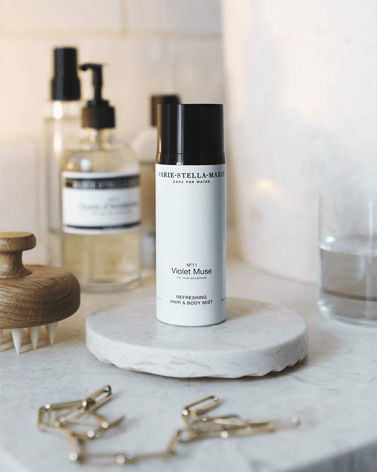 Bottle of Marie-Stella-Maris hair and body mist in the Violet Muse scent on a bathroom counter