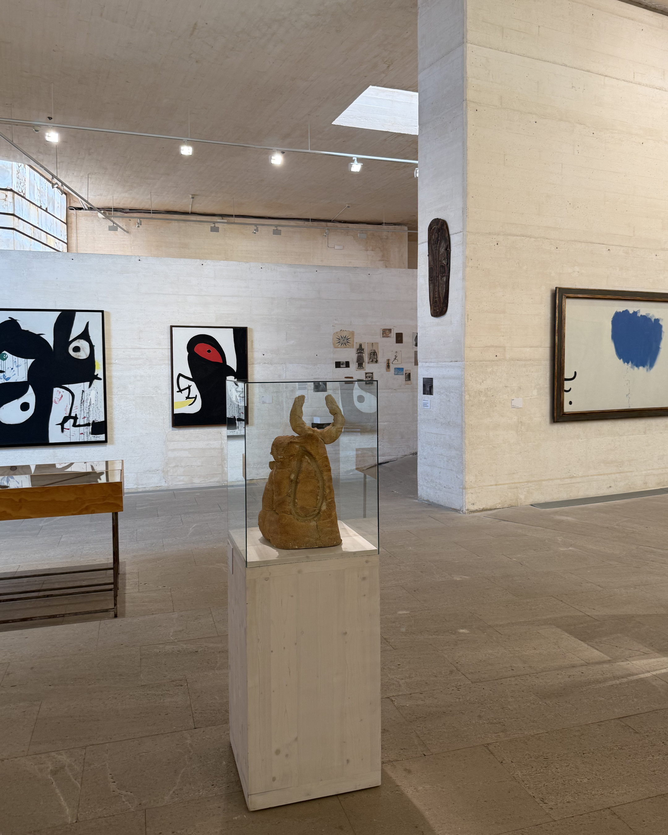 Exhibition gallery at Fundació Miró Mallorca featuring Joan Miró's abstract paintings, sculptures and drawings in a minimalist setting.