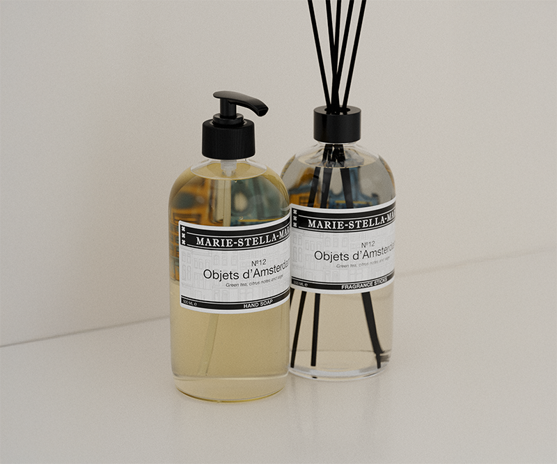 hand soap bottle and fragrance sticks bottle in the Objets d'Amsterdam scent on a white background