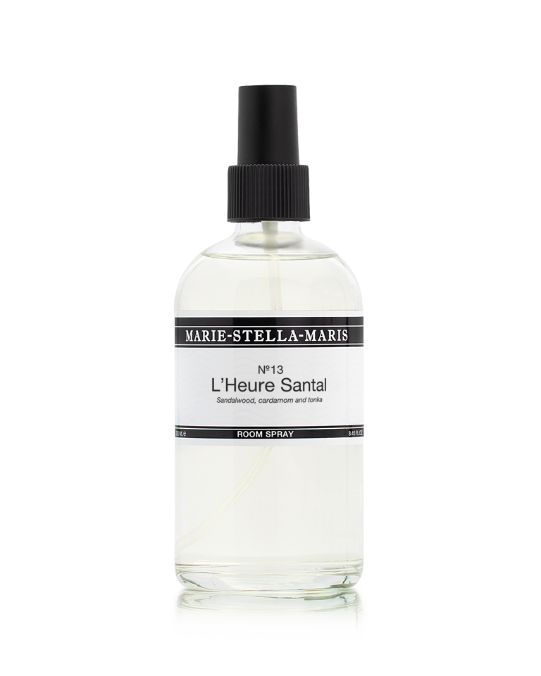 Marie-Stella-Maris Room Spray in No.13 L’Heure Santal, presented in a clear glass spray bottle with a black spray cap. The signature fragrance features notes of sandalwood, cardamom and tonka, photographed against a clean white background.