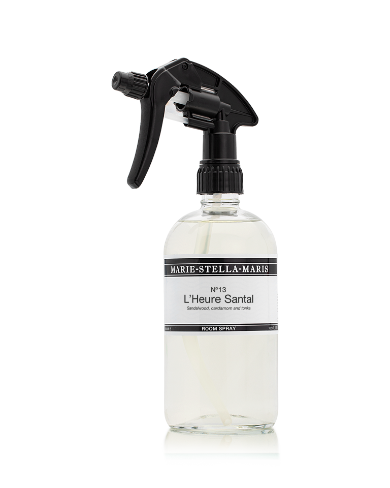 Marie-Stella-Maris Room Spray in No.13 L’Heure Santal, presented in a clear glass spray bottle with a black trigger spray. The label features the signature fragrance with notes of sandalwood, cardamom and tonka, photographed against a clean white background.
