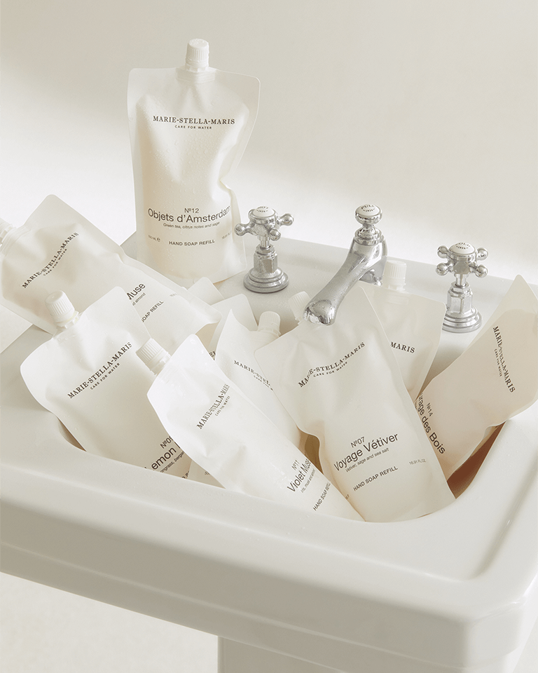 Marie-Stella-Maris white bathroom sink filled with hand soap refill pouches 500 ml.