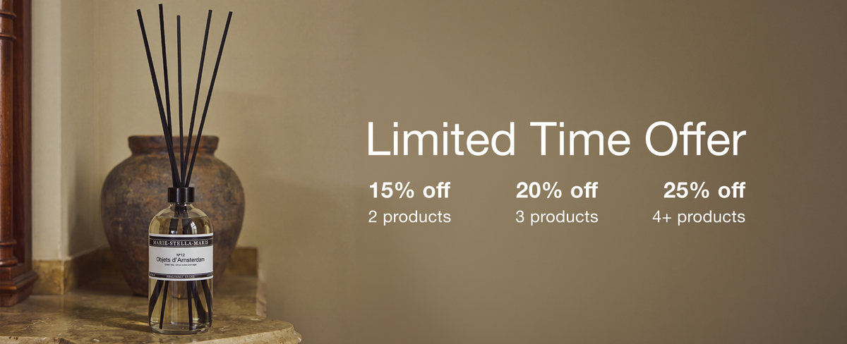 Marie-Stella-Maris home stick scent in No.12 Objets d'Amsterdam sitting on a marble side table in front of a rustic vase on beige khaki background showcasing the Home Essentials Promo. 