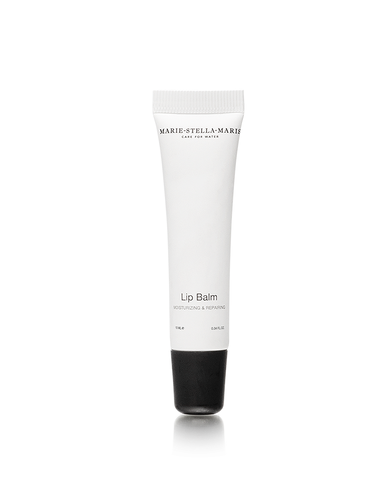 Marie-Stella-Maris white tube of lip balm with a black cap on a light grey background