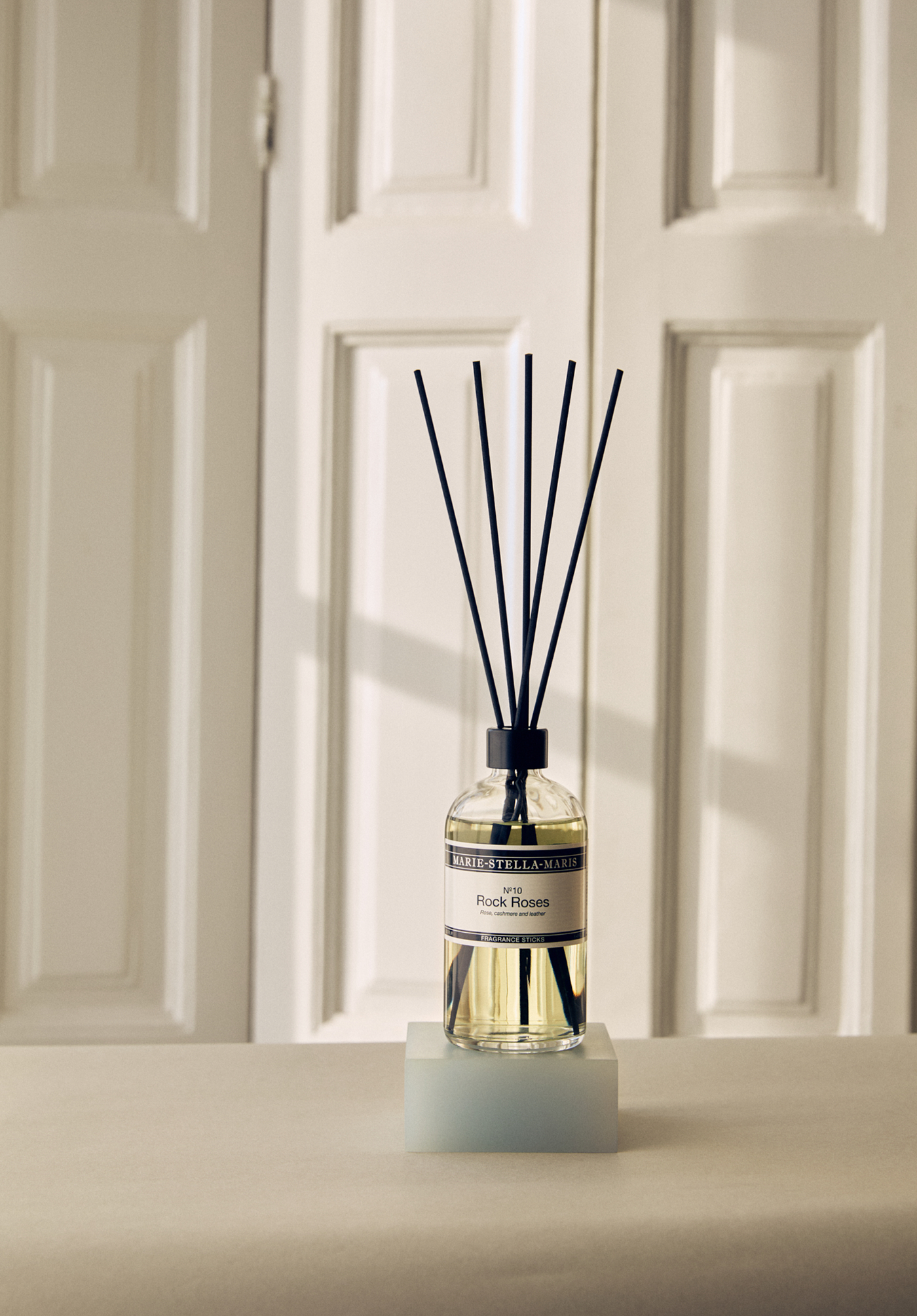 Marie-Stella-Maris Rock Roses Fragrance Sticks in front of white doors