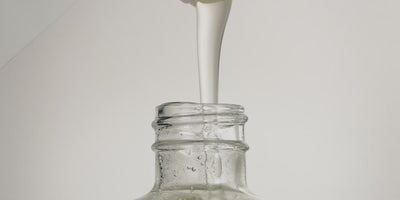 Close-up video of a Marie-Stella-Maris refill being poured into a reusable glass hand soap bottle. A smooth stream of liquid flows into the bottle against a clean, neutral background, illustrating the Marie-Stella-Maris refill subscription and the ease of replenishing hand soap at home with less packaging waste.