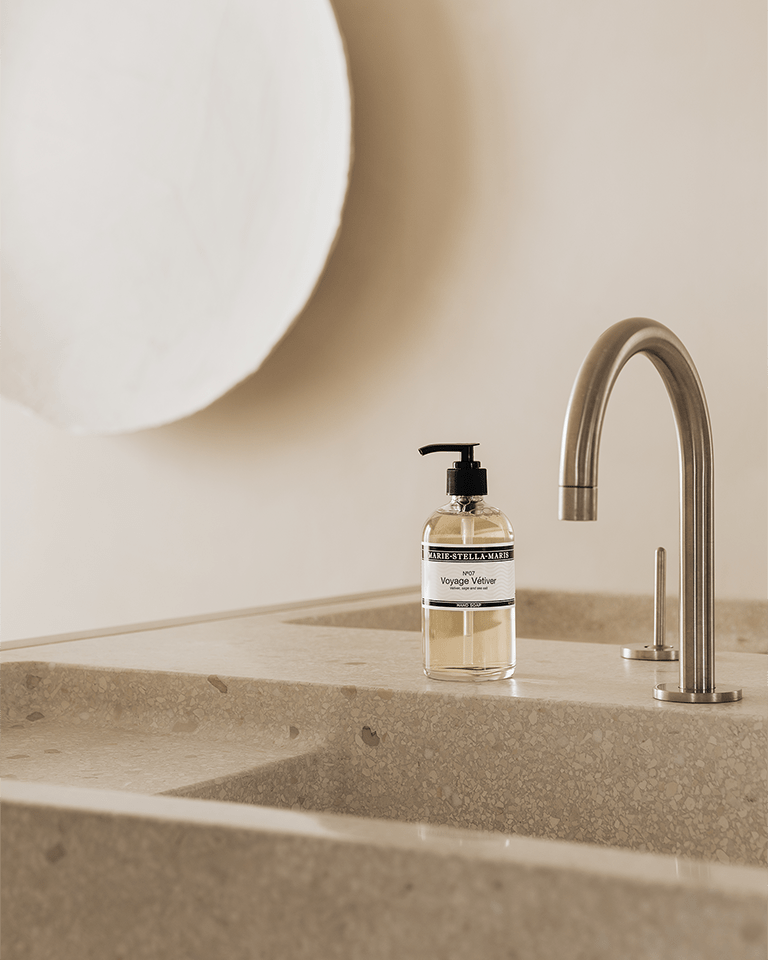 Marie-Stella-Maris Hand Soap No.07 Voyage Vétiver 250 ml placed beside a modern stainless steel faucet on a minimalist stone sink, creating a calm and refined bathroom setting.
